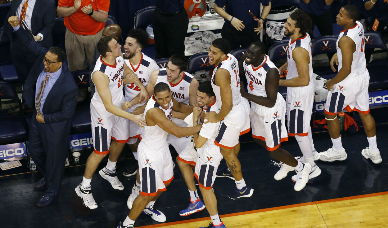 Mar 5, 2016; Charlottesville, VA, USA; Virginia Cavaliers players celebrate on the bench after a three point feel goal by Cavaliers forward Caid Kirven (not pictured) in the final minute against the Louisville Cardinals at John Paul Jones Arena. The Cavaliers won 68-46. Mandatory Credit: Geoff Burke-USA TODAY Sports